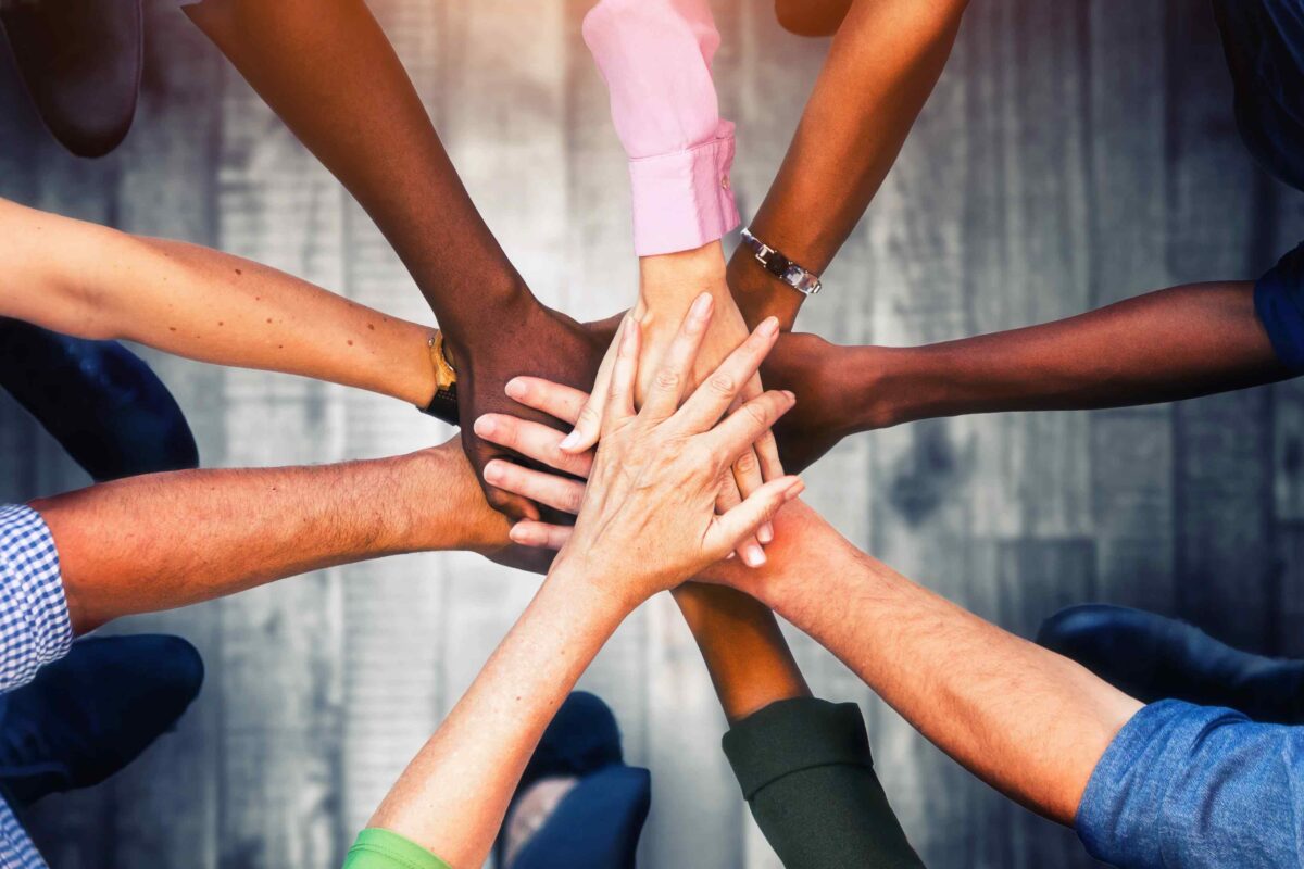 A group of people with their hands together.