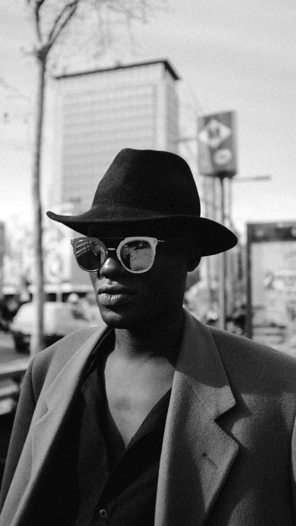 A man wearing glasses and a hat.