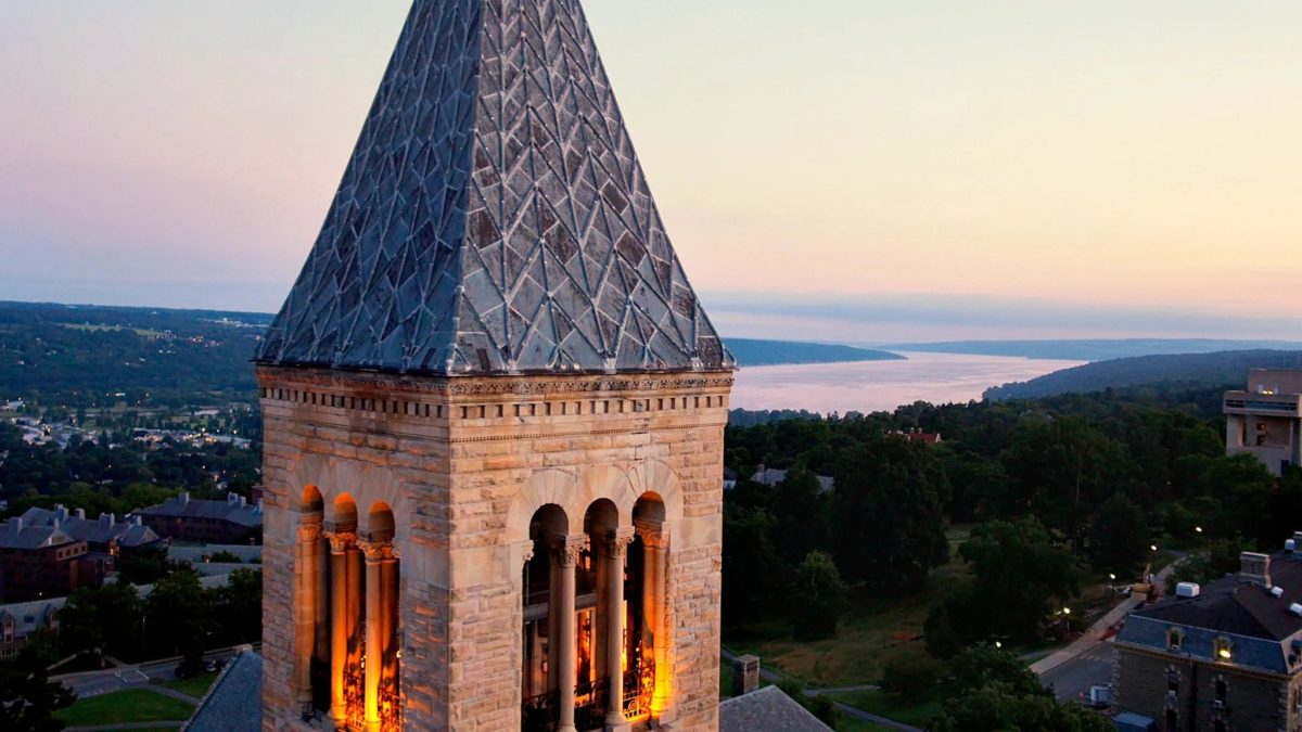 A large stone tower with a clock on it's side.