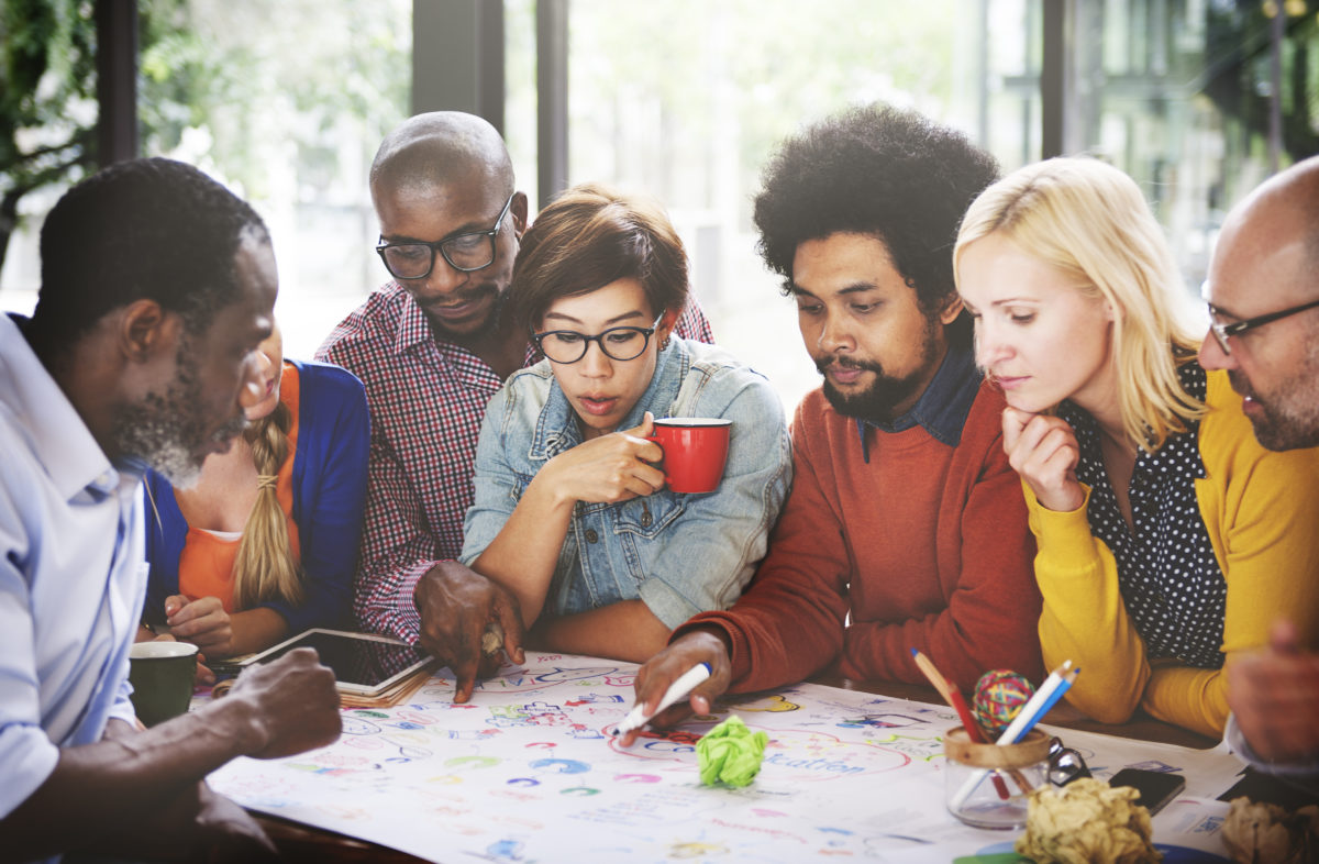 A group of people sitting around a table.